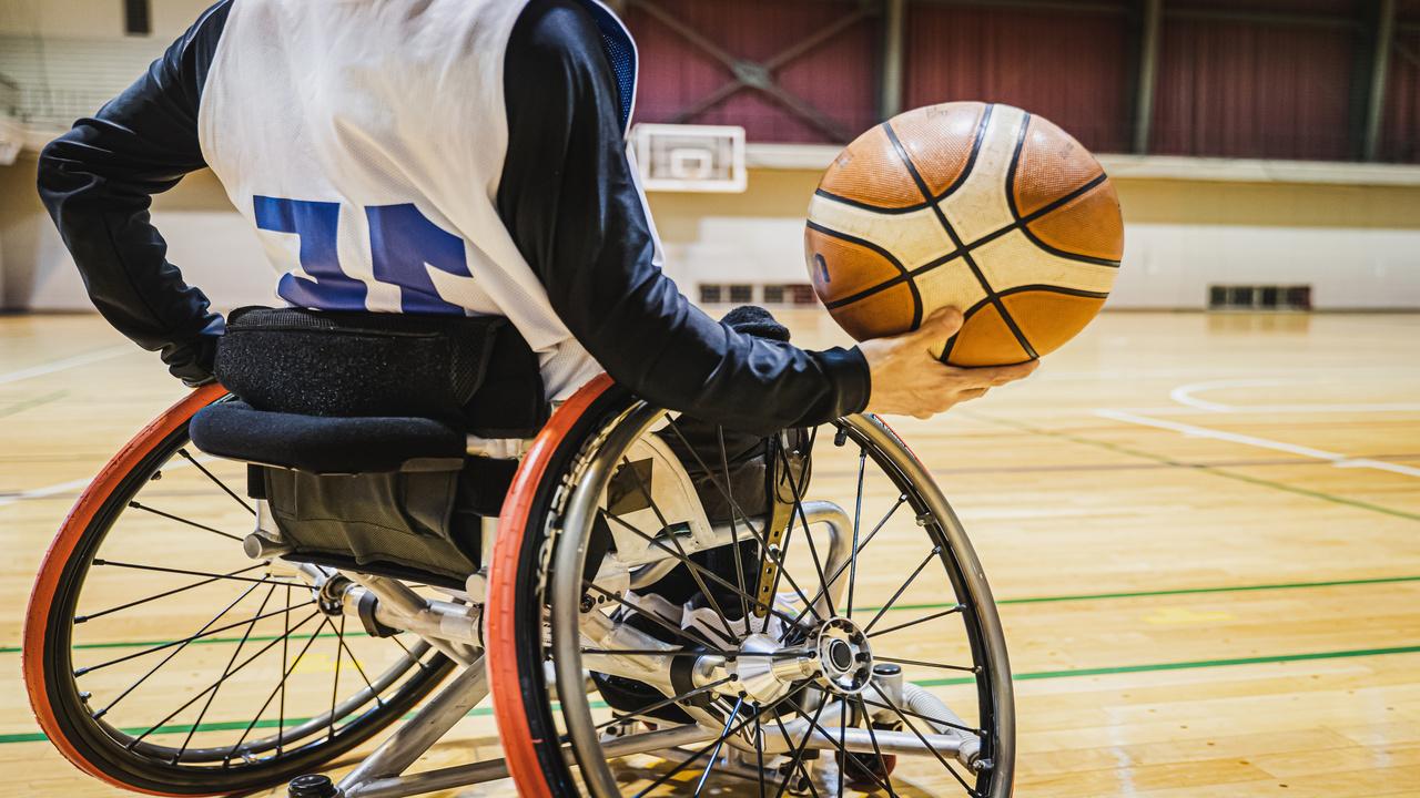 A person in a wheelchair playing basketball.